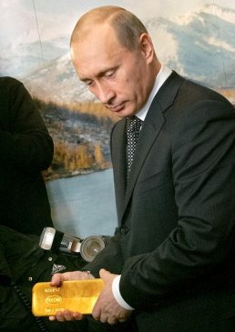 Президент России Владимир Путин держит слиток золота
